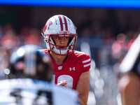 Wisconsin Badgers quarterback Braedyn Locke #18 observes the Purdue Boilermakers defense at Camp Randall Stadium in Madison, Wisconsin, on O...