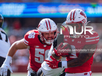 Wisconsin Badgers running back Tawee Walker #3 runs in a touchdown against the Purdue Boilermakers at Camp Randall Stadium in Madison, Wisco...