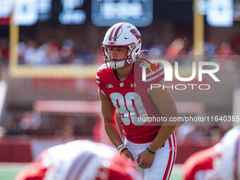 Wisconsin Badgers kicker Nathanial Vakos #90 lines up an extra point against the Purdue Boilermakers at Camp Randall Stadium in Madison, Wis...