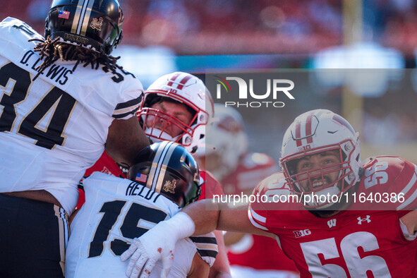 Wisconsin Badgers offensive lineman Joe Brunner #56 braces for an extra point against the Purdue Boilermakers at Camp Randall Stadium in Mad...