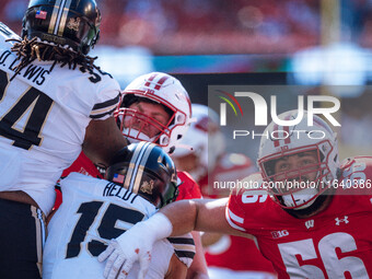 Wisconsin Badgers offensive lineman Joe Brunner #56 braces for an extra point against the Purdue Boilermakers at Camp Randall Stadium in Mad...