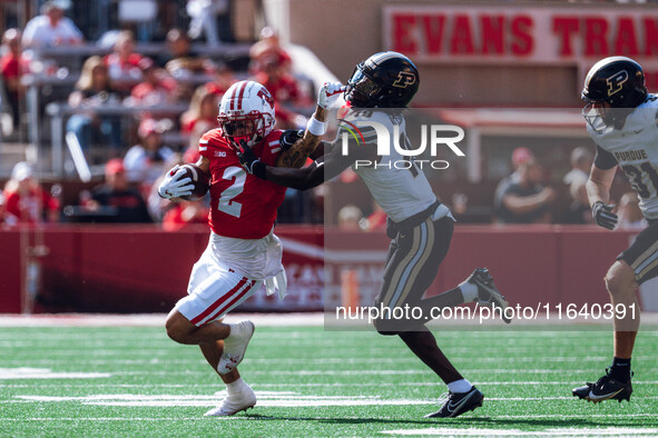 Wisconsin Badgers wide receiver Trech Kekahuna #2 gives a stiff arm to Purdue defensive back Botros Alisandro #19 at Camp Randall Stadium in...