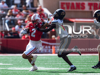 Wisconsin Badgers wide receiver Trech Kekahuna #2 gives a stiff arm to Purdue defensive back Botros Alisandro #19 at Camp Randall Stadium in...