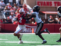 Wisconsin Badgers wide receiver Trech Kekahuna #2 gives a stiff arm to Purdue defensive back Botros Alisandro #19 at Camp Randall Stadium in...