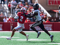 Wisconsin Badgers wide receiver Trech Kekahuna #2 gives a stiff arm to Purdue defensive back Botros Alisandro #19 at Camp Randall Stadium in...