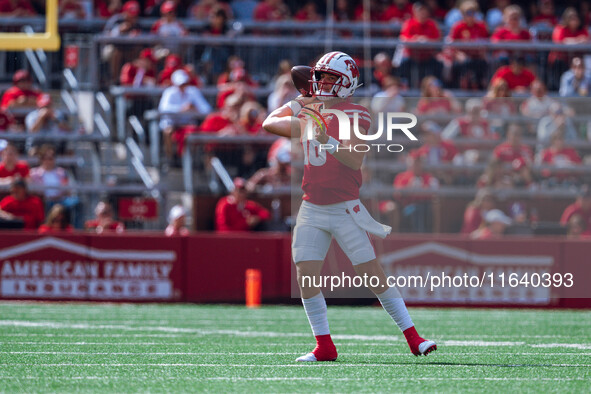 Wisconsin Badgers quarterback Braedyn Locke #18 throws a pass against the Purdue Boilermakers at Camp Randall Stadium in Madison, Wisconsin,...