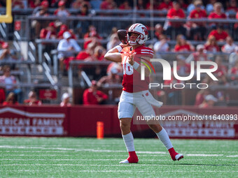 Wisconsin Badgers quarterback Braedyn Locke #18 throws a pass against the Purdue Boilermakers at Camp Randall Stadium in Madison, Wisconsin,...