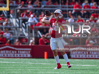 Wisconsin Badgers quarterback Braedyn Locke #18 throws a pass against the Purdue Boilermakers at Camp Randall Stadium in Madison, Wisconsin,...