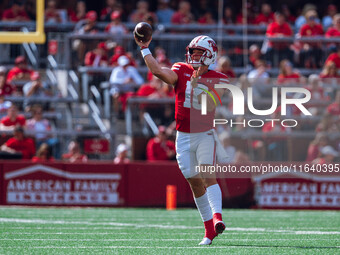 Wisconsin Badgers quarterback Braedyn Locke #18 throws a pass against the Purdue Boilermakers at Camp Randall Stadium in Madison, Wisconsin,...