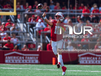 Wisconsin Badgers quarterback Braedyn Locke #18 throws a pass against the Purdue Boilermakers at Camp Randall Stadium in Madison, Wisconsin,...