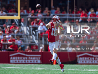 Wisconsin Badgers quarterback Braedyn Locke #18 throws a pass against the Purdue Boilermakers at Camp Randall Stadium in Madison, Wisconsin,...