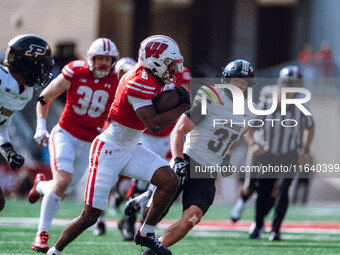 Wisconsin Badgers wide receiver Vinny Anthony II #8 outruns the Purdue Boilermakers for a touchdown at Camp Randall Stadium in Madison, Wisc...