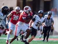 Wisconsin Badgers wide receiver Vinny Anthony II #8 outruns the Purdue Boilermakers for a touchdown at Camp Randall Stadium in Madison, Wisc...