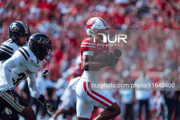 Wisconsin Badgers wide receiver Vinny Anthony II #8 outruns the Purdue Boilermakers for a touchdown at Camp Randall Stadium in Madison, Wisc...