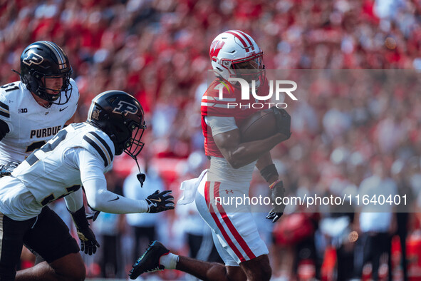 Wisconsin Badgers wide receiver Vinny Anthony II #8 outruns the Purdue Boilermakers for a touchdown at Camp Randall Stadium in Madison, Wisc...