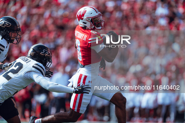 Wisconsin Badgers wide receiver Vinny Anthony II #8 outruns the Purdue Boilermakers for a touchdown at Camp Randall Stadium in Madison, Wisc...