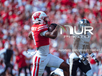 Wisconsin Badgers wide receiver Vinny Anthony II #8 outruns the Purdue Boilermakers for a touchdown at Camp Randall Stadium in Madison, Wisc...