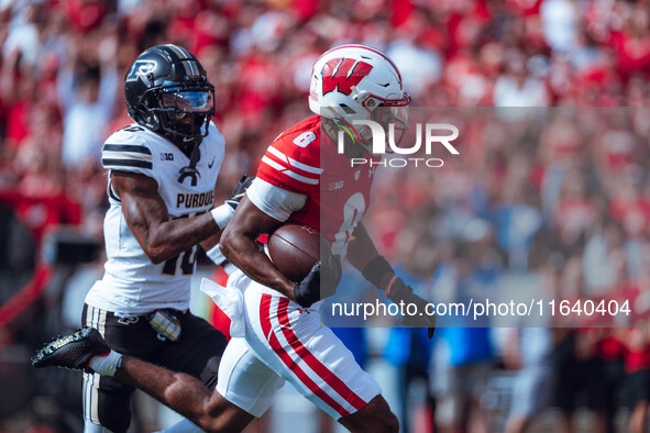 Wisconsin Badgers wide receiver Vinny Anthony II #8 outruns the Purdue Boilermakers for a touchdown at Camp Randall Stadium in Madison, Wisc...