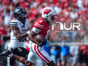 Wisconsin Badgers wide receiver Vinny Anthony II #8 outruns the Purdue Boilermakers for a touchdown at Camp Randall Stadium in Madison, Wisc...