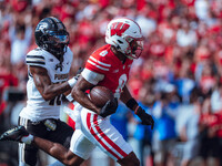 Wisconsin Badgers wide receiver Vinny Anthony II #8 outruns the Purdue Boilermakers for a touchdown at Camp Randall Stadium in Madison, Wisc...