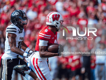 Wisconsin Badgers wide receiver Vinny Anthony II #8 outruns the Purdue Boilermakers for a touchdown at Camp Randall Stadium in Madison, Wisc...