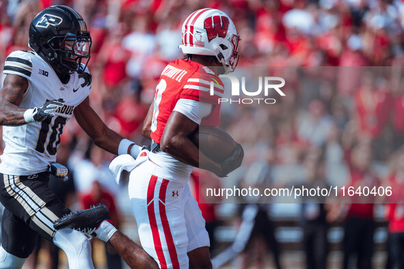 Wisconsin Badgers wide receiver Vinny Anthony II #8 outruns the Purdue Boilermakers for a touchdown at Camp Randall Stadium in Madison, Wisc...