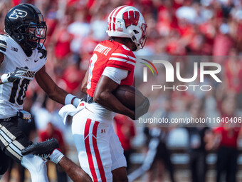 Wisconsin Badgers wide receiver Vinny Anthony II #8 outruns the Purdue Boilermakers for a touchdown at Camp Randall Stadium in Madison, Wisc...