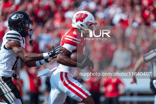 Wisconsin Badgers wide receiver Vinny Anthony II #8 outruns the Purdue Boilermakers for a touchdown at Camp Randall Stadium in Madison, Wisc...