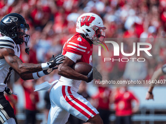 Wisconsin Badgers wide receiver Vinny Anthony II #8 outruns the Purdue Boilermakers for a touchdown at Camp Randall Stadium in Madison, Wisc...