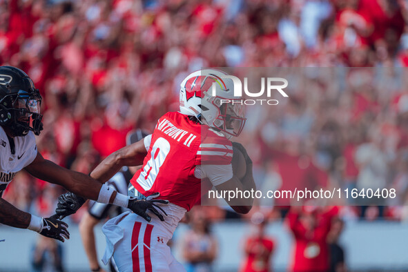 Wisconsin Badgers wide receiver Vinny Anthony II #8 outruns the Purdue Boilermakers for a touchdown at Camp Randall Stadium in Madison, Wisc...