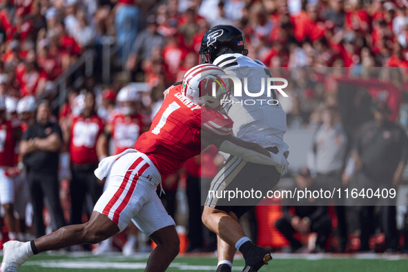 Wisconsin Badgers inside linebacker Jake Chaney #1 pressures Purdue quarterback Hudson Card #1 at Camp Randall Stadium in Madison, Wisconsin...