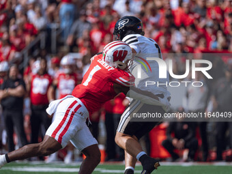 Wisconsin Badgers inside linebacker Jake Chaney #1 pressures Purdue quarterback Hudson Card #1 at Camp Randall Stadium in Madison, Wisconsin...