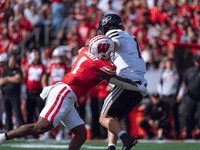 Wisconsin Badgers inside linebacker Jake Chaney #1 pressures Purdue quarterback Hudson Card #1 at Camp Randall Stadium in Madison, Wisconsin...