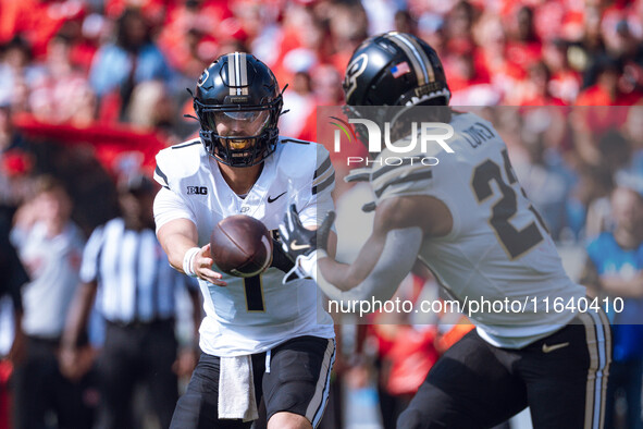 Purdue quarterback Hudson Card #1 pitches the ball to running back Reggie Love III #23 against the Wisconsin Badgers at Camp Randall Stadium...