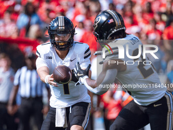 Purdue quarterback Hudson Card #1 pitches the ball to running back Reggie Love III #23 against the Wisconsin Badgers at Camp Randall Stadium...