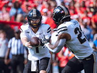 Purdue quarterback Hudson Card #1 pitches the ball to running back Reggie Love III #23 against the Wisconsin Badgers at Camp Randall Stadium...