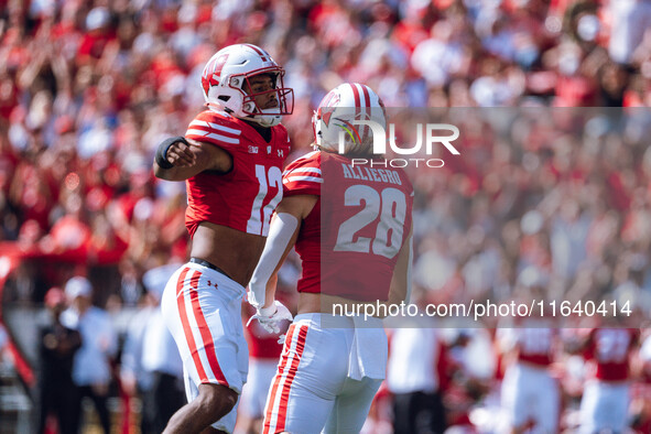 Wisconsin Badgers linebacker Christian Alliegro #28 and cornerback Max Lofy #12 celebrate a defensive stop against the Purdue Boilermakers a...