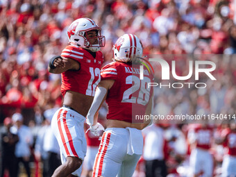 Wisconsin Badgers linebacker Christian Alliegro #28 and cornerback Max Lofy #12 celebrate a defensive stop against the Purdue Boilermakers a...