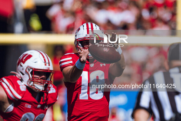 Wisconsin Badgers quarterback Braedyn Locke #18 takes a snap against the Purdue Boilermakers at Camp Randall Stadium in Madison, Wisconsin,...