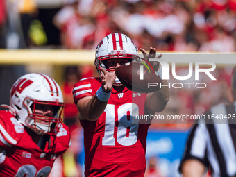 Wisconsin Badgers quarterback Braedyn Locke #18 takes a snap against the Purdue Boilermakers at Camp Randall Stadium in Madison, Wisconsin,...