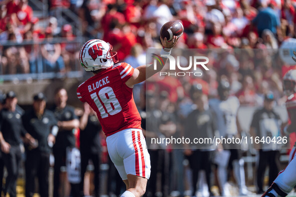 Wisconsin Badgers quarterback Braedyn Locke #18 throws a pass against the Purdue Boilermakers at Camp Randall Stadium in Madison, Wisconsin,...