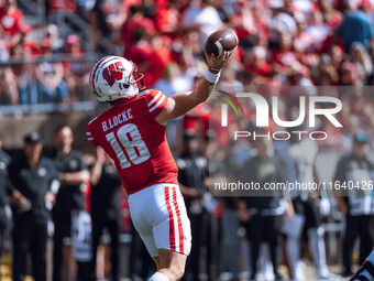 Wisconsin Badgers quarterback Braedyn Locke #18 throws a pass against the Purdue Boilermakers at Camp Randall Stadium in Madison, Wisconsin,...