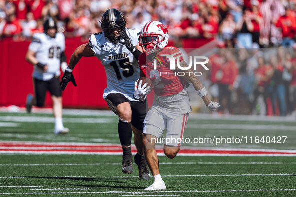 Wisconsin Badgers wide receiver Trech Kekahuna #2 outruns the Purdue Boilermakers defense for a touchdown at Camp Randall Stadium in Madison...