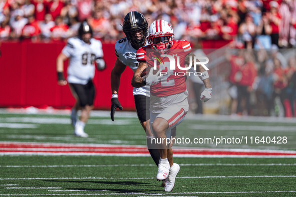 Wisconsin Badgers wide receiver Trech Kekahuna #2 outruns the Purdue Boilermakers defense for a touchdown at Camp Randall Stadium in Madison...