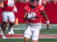 Wisconsin Badgers wide receiver Trech Kekahuna #2 outruns the Purdue Boilermakers defense for a touchdown at Camp Randall Stadium in Madison...