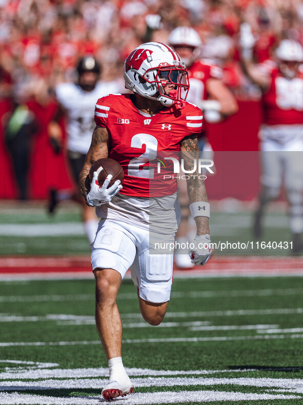 Wisconsin Badgers wide receiver Trech Kekahuna #2 outruns the Purdue Boilermakers defense for a touchdown at Camp Randall Stadium in Madison...