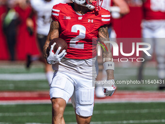 Wisconsin Badgers wide receiver Trech Kekahuna #2 outruns the Purdue Boilermakers defense for a touchdown at Camp Randall Stadium in Madison...