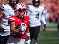 Wisconsin Badgers wide receiver Trech Kekahuna #2 outruns the Purdue Boilermakers defense for a touchdown at Camp Randall Stadium in Madison...