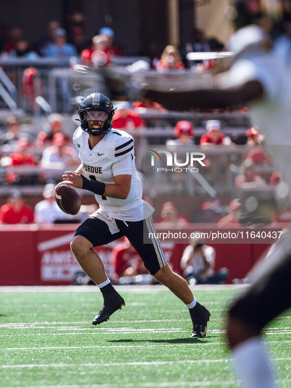 Purdue Boilermakers quarterback Hudson Card #1 looks downfield for an open receiver against the Wisconsin Badgers at Camp Randall Stadium in...