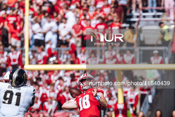 Wisconsin Badgers quarterback Braedyn Locke #18 throws a deep pass against the Purdue Boilermakers at Camp Randall Stadium in Madison, Wisco...